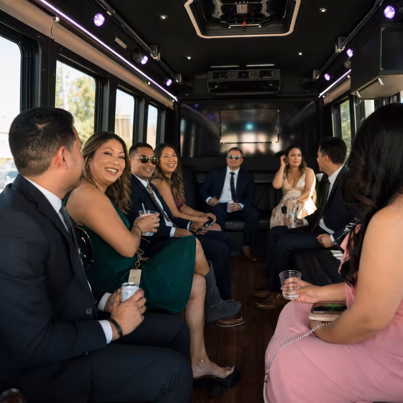 Wedding guests seated inside a Garden Grove party bus