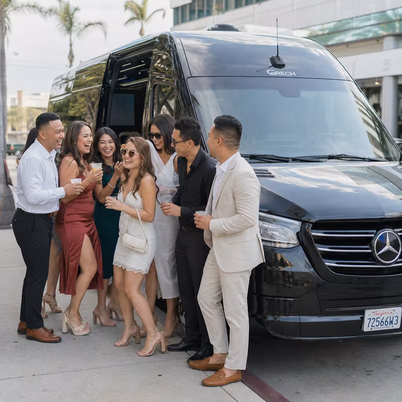 Group boarding a white charter bus for Bachelor & Bachelorette Transportation transportation in Garden Grove