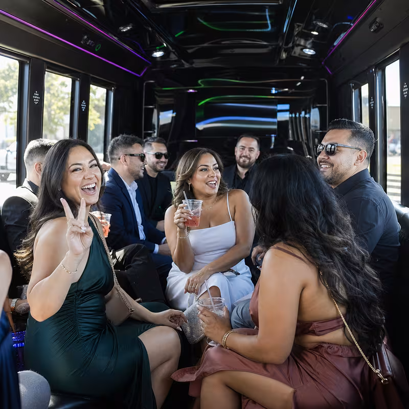 Party bus interior with wraparound leather seating and LED lighting in Garden Grove