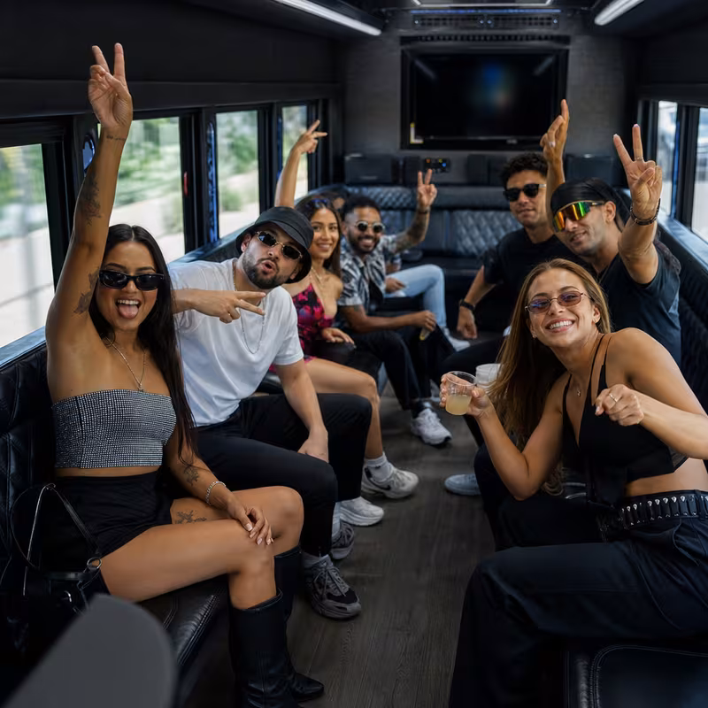Group boarding a white charter bus for Concert Transportation transportation in Garden Grove