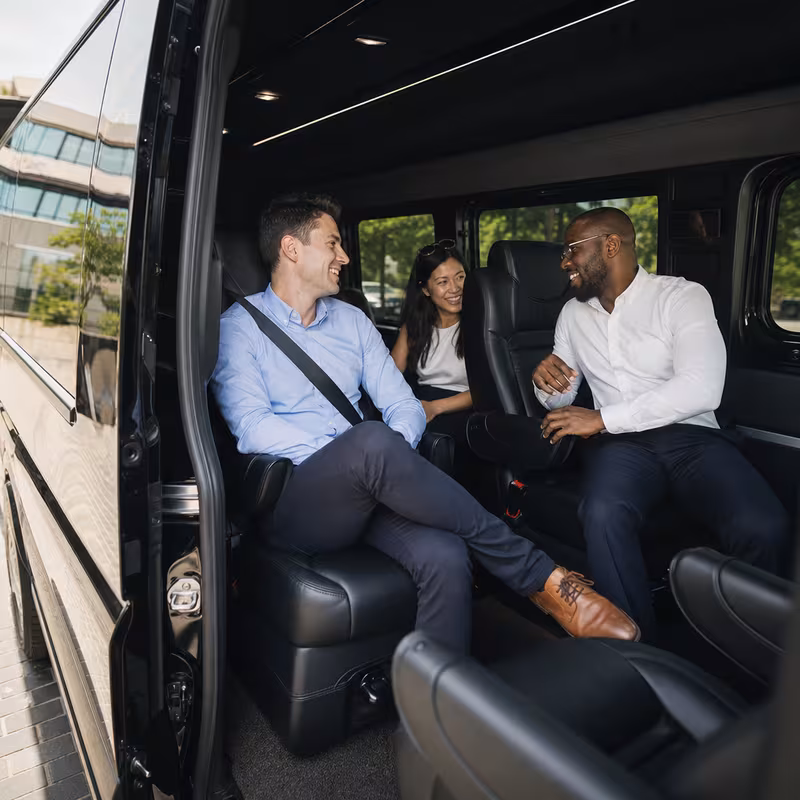 Group boarding a white charter bus for Corporate Transportation transportation in Garden Grove