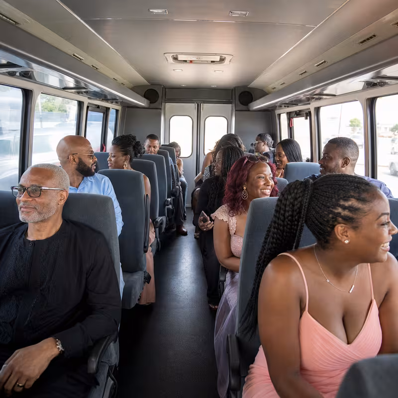 Group boarding a white charter bus for Private Event Transportation transportation in Garden Grove