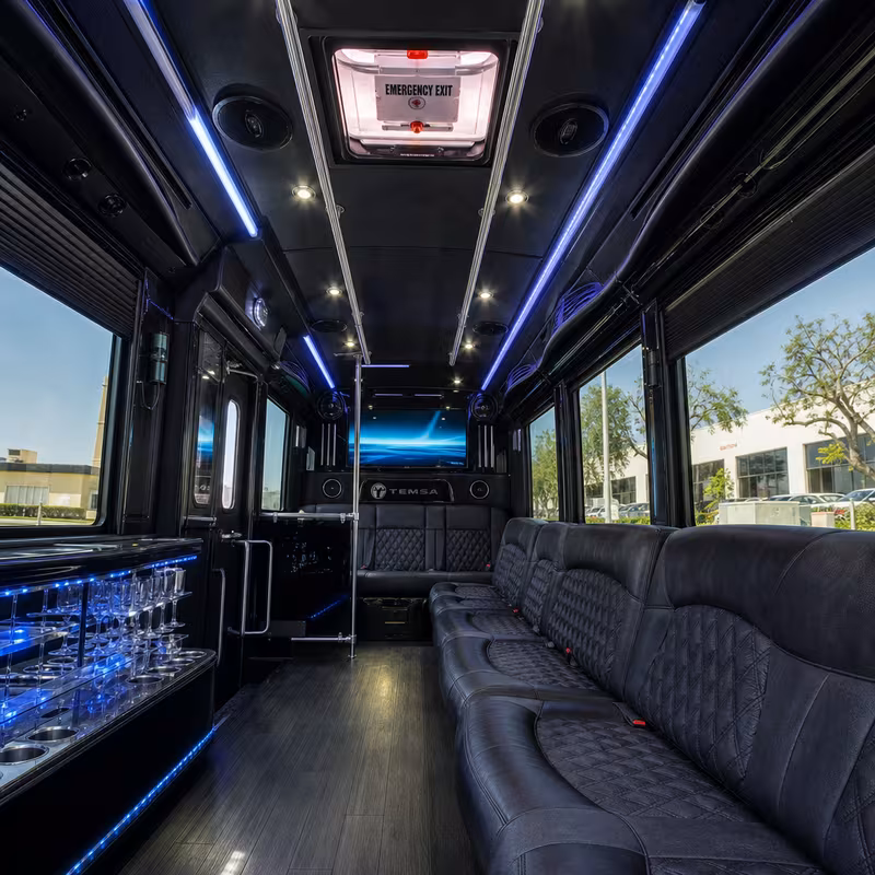 Party bus interior with wraparound leather seating and LED lighting in Garden Grove