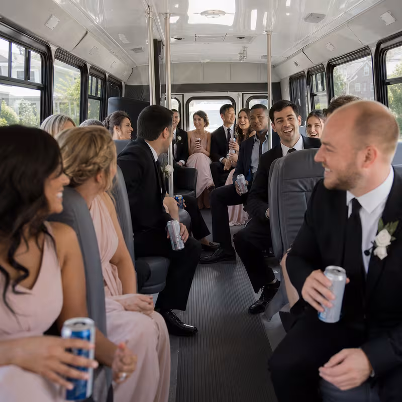 Group boarding a white charter bus for Wedding Transportation transportation in Garden Grove