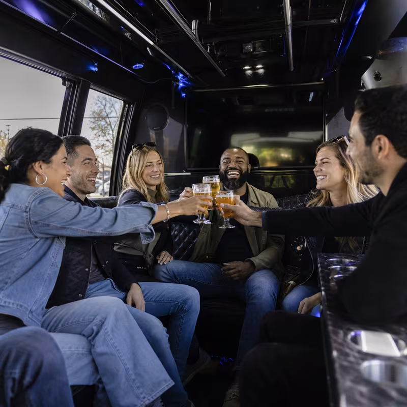 Group boarding a white charter bus for Winery & Brewery Tour Transportation transportation in Garden Grove